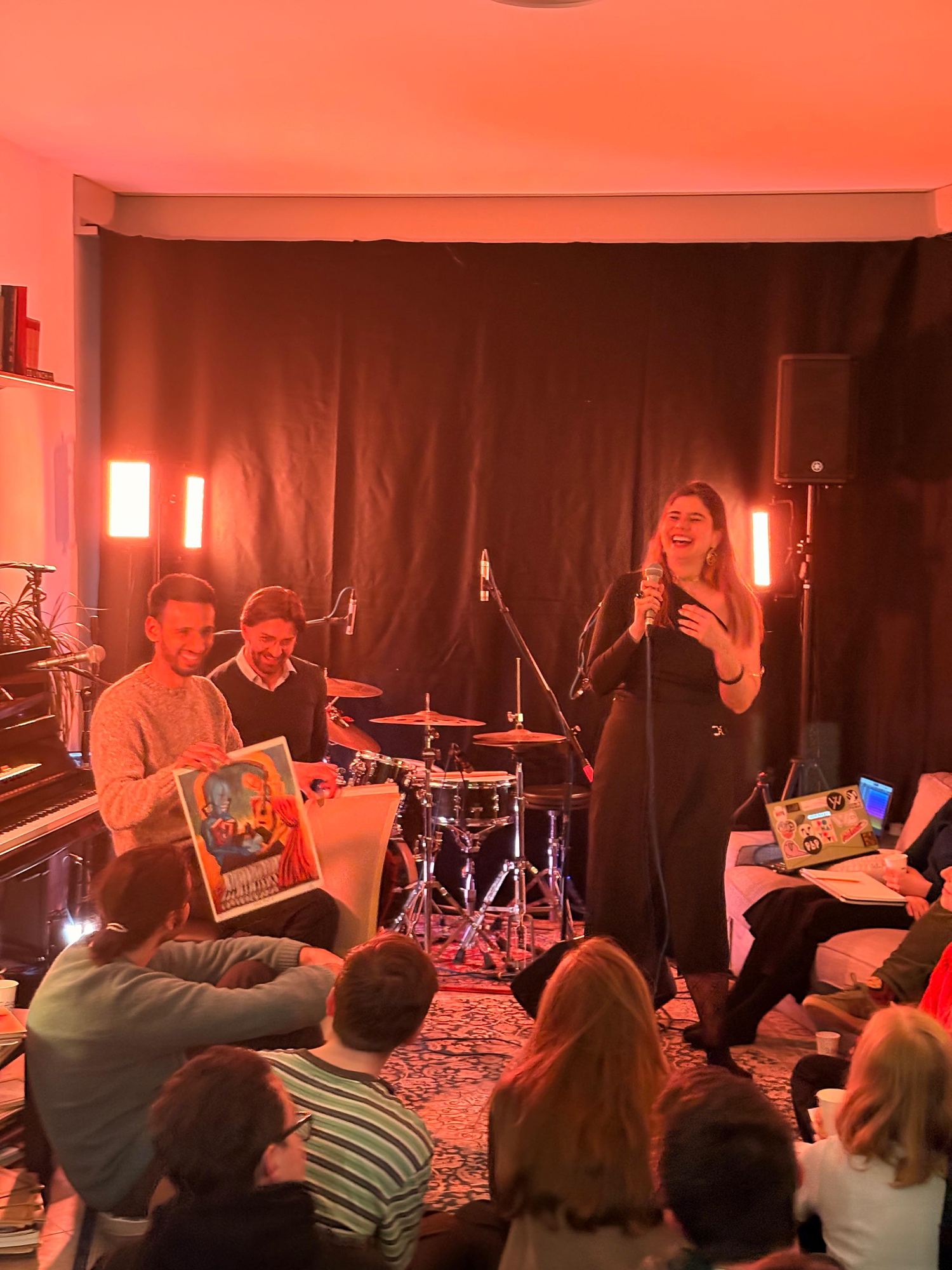Villagers sharing artwork and a microphone at Composing Villagers 1